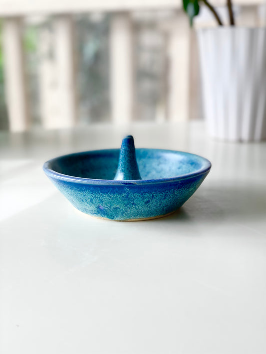 Ring Dish with a speckled ocean-blue glaze and a smooth center ring stem